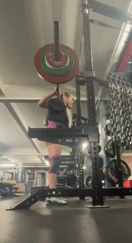 Kate squats the barbell at a much slower speed